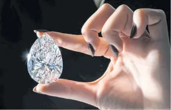  ?? AFP ?? ABOVE
‘The Rock’, a 228.31-carat pear-shaped white diamond, is pictured during a preview at Christie’s before their auction sale in Geneva.