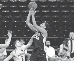  ?? NAM Y. HUH/AP ?? Iowa forward Keegan Murray, center, goes up for a shot against Northweste­rn on Sunday in Evanston, Ill.