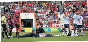  ??  ?? FLAT OUT Everton’s Michael Keane (left) and Idrissa Gueye are hurt after a clash of heads