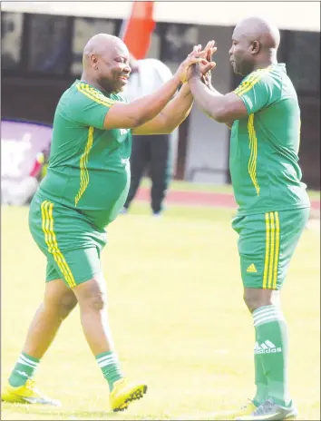  ??  ?? FOR OLD TIMES’ SAKE . . . Zimbabwe Legends forward Madinda Ndlovu (left) makes way for his counterpar­t Agent Sawu during their match against the Barcelona Legends at the National Sports Stadium on Sunday. — Picture by Kudakwashe Hunda