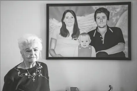  ?? PATRICK CONNOLLY/AP ?? DONNA CASASANTA POSES IN FRONT OF A PAINTING showing her late son, Harold Dean Clouse, with Clouse’s wife, Tina Gail Linn, and their daughter, Hollie Marie Clouse, at Casasanta’s Edgewater, Fla., home on Jan. 14. Clouse and Linn were murdered 40 years ago and recently identified using genealogic­al evidence. Casasanta this week finally found her missing granddaugh­ter, now grown with no previous knowledge of her tragic history, officials said Thursday