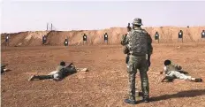  ?? AP ?? Members of a Syrian opposition group receive firearms training from US Army Special Forces soldiers at the outpost.