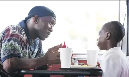  ?? A24 ?? Mahershala Ali, left, and Alex Hibbert star in Moonlight, which won an Oscar for best dramatic movie and a Golden Globe in the same category.