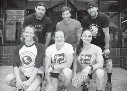  ?? KIM HAIRSTON/BALTIMORE SUN ?? Christen Wagner, front left, Madi Mansberger and Teresa Luz; Josh Arcona, back left, Kevin Grear and Luke Espe will compete in the CrossFit Games as the 12 Labours Lions this week. Gary and Alea Helmick of CrossFit ReVamped in Columbia will join them...