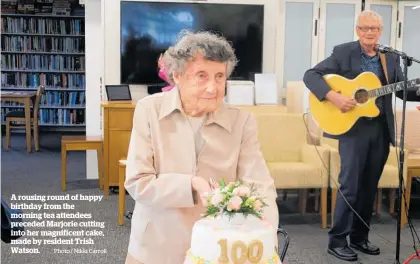  ?? Photo / Nikki Carroll ?? A rousing round of happy birthday from the morning tea attendees preceded Marjorie cutting into her magnificen­t cake, made by resident Trish Watson.