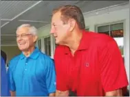  ??  ?? Former Philadelph­ia Eagles coach Dick Vermeil, left, shares a laugh with former Philadelph­ia Phillies pitcher Larry Christenso­n as they wait for the rain to end during the 21st annual Dick Vermeil Invitation­al golf outing to benefit Boy Scouts of...