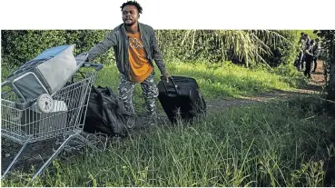  ?? Picture: Getty Images/Antonio Masiello ?? Migrants are ordered out of an occupied building in Rome under a policy by the new anti-migrant government that has given the green light to evictions of the men, women and children who have taken shelter in abandoned buildings.