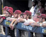  ?? NWA Democrat-Gazette/J.T. WAMPLER ?? Arkansas players watch the last few minutes of Saturday’s loss to LSU in Hoover, Ala., from the dugout. The Razorbacks will learn who they’ll play in the NCAA Tournament when pairings are announced Monday.