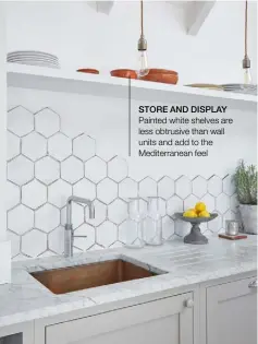  ??  ?? STORE AND DISPLAY Painted white shelves are less obtrusive than wall units and add to the Mediterran­ean feel