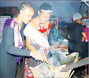  ?? ?? Miss Eswatini Second Princess Fezile Mthupha (L) and Miss Cultural Heritage Lindelwa Maziya preparing some of the meat during the Biggest Braai launch.