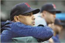  ?? AP PHOTO ?? KEEPING AN EYE ON THINGS: Manager Alex Cora watches from the dugout last night as the Red Sox started a three-game series against the Orioles in Baltimore.