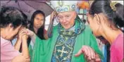  ?? REUTERS FILE ?? People greet Theodore McCarrick in Palo, Philippine­s.