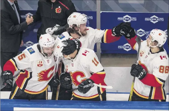  ?? Jason franson / the Canadian Press via AP ?? the flames used size and toughness to oust Winnipeg in the qualifying round and earn a first-round meeting with third-seeded dallas starting tuesday.