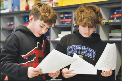  ?? ?? Miles Tunstill, left, and Grayson Pollard go over their lines of a three-scene play written by CHATGPT in Piercey’s class. Parameters of the play were entered into the CHATGPT site, along with instructio­ns to set the scenes inside a fifth-grade classroom. Line-by-line, it generated fully-formed scripts, which the students edited, briefly rehearsed and then performed.