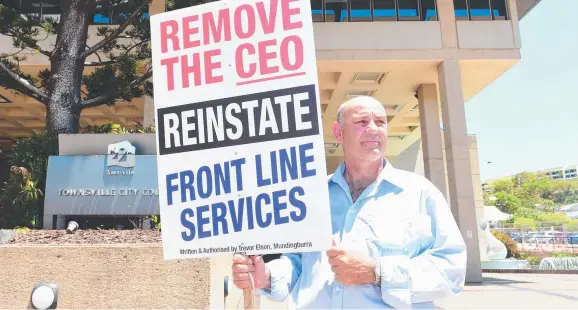  ?? DETERMINED STAND: Former waste inspector Trevor Elson outside the Townsville City Council building yesterday with his protest sign. Picture: SCOTT RADFORD- CHISHOLM ??