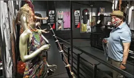  ?? TONY DEJAK PHOTOS / AP ?? Ed Pauley looks at an exhibit at the Rock and Roll Hall of Fame on Monday in Cleveland. The Rock and Roll Hall of Fame reopened to the public Monday with new health and safety precaution­s in place to protect staff and guests.