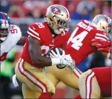  ?? NHAT V. MEYER/TRIBUNE NEWS SERVICE ?? San Francisco 49ers' Carlos Hyde (28) runs against the New York Giants in the second quarter on Sunday.