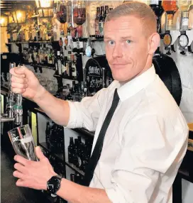  ??  ?? Pulling pints Adam gets ready for another shift at East Kilbride’s oldest pub