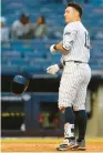  ?? JOHN MUNSON/AP ?? Anthony Volpe tosses his helmet after striking out with the bases loaded to end the eighth inning against the Diamondbac­ks last week.