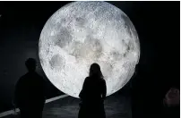  ?? Photo / Supplied ?? The centrepiec­e of the exhibition is a giant fourmetre diameter orb made by British artist Luke Jerram, glowing with high-definition NASA lunar surface imagery.