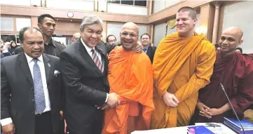  ??  ?? Zahid (second left) shares a light moment with participan­ts of internatio­nal symposium on ‘Moderation in Multi-religious Societies:Towards Peace and Harmony’. — Bernama photo