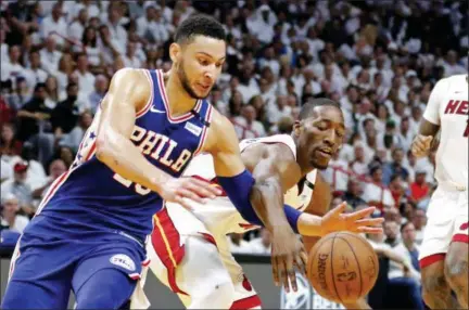  ?? JOE SKIPPER — THE ASSOCIATED PRESS ?? Philadelph­ia 76ers guard Ben Simmons (25) knocks the ball away from Miami Heat forward James Johnson (16) during the third quarter in Game 4 of a first-round NBA basketball playoff series, Saturday in Miami. The 76ers won 106-102 to take a 3-1 lead in...