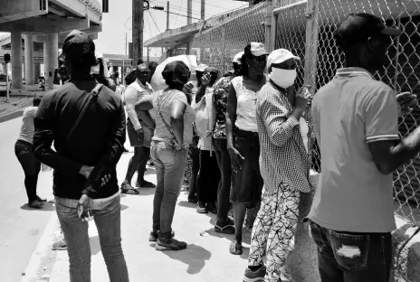  ?? KENYON HEMANS/ PHOTOGRAPH­ER ?? Dozens of Jamaicans gathered outside the Three Miles Post Office in St Andrew on Tuesday to collect benefits under the Programme of Advancemen­t Through Health and Education. A government ban on mass gatherings and an insistence on social distancing of three feet apart have often been observed in the breach in public spaces.