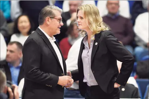  ?? Jessica Hill / Associated Press ?? UConn coach Geno Auriemma, left, talks with Tennessee coach Kellie Harper before a game in Hartford last January.
