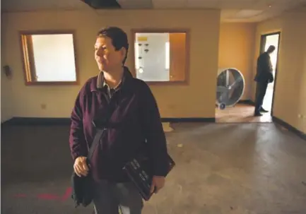  ??  ?? Brendalee Connors, chief real estate officer with Metro West Housing Solutions, looks over the interior of an abandoned office building at 5800 W. Alameda Ave. in Lakewood on Thursday. Helen H. Richardson, The Denver Post