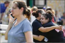  ?? MICHAEL CIAGLO / HOUSTON CHRONICLE ?? Santa Fe High School junior Guadalupe Sanchez, 16, cries into the arms of her mother, Elida Sanchez, after reuniting with her at Alamo Gym following the shooting at Santa Fe High School on Friday.