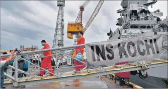  ??  ?? Rescued crew members from the sunken offshore barge P305 disembark the INS Kochi in Mumbai on Wednesday.