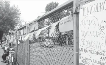  ??  ?? Sobre el muro de protección del mercado de Medellín, los vecinos colocaron carteles con las principale­s afectacion­es en la zona ■ Fotos Rocío González