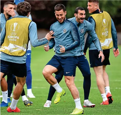  ??  ?? Joker in the pack: Hazard (centre) shares a joke with Zappacosta in training yesterday