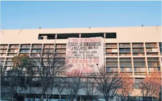  ??  ?? A banner against the government’s reforms hangs on a wall at Thessaloni­ki’s Aristotle University in a recent photo.