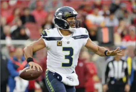  ?? DON FERIA — THE ASSOCIATED PRESS ?? Seahawks quarterbac­k Russell Wilson, here looking for an open receiver against the San Francisco 49ers last Sunday, will be one of the Eagles defense’s stiffest quarterbac­k tests of the season when the teams meet in Seattle this Sunday night.