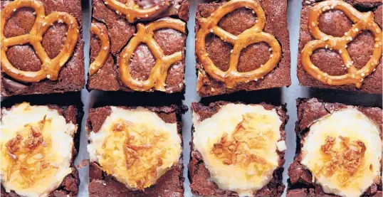  ?? YOSSY AREFI/THE NEW YORK TIMES ?? Stuffed or topped with the likes of sugared coconut, graham crackers or salted pretzels, these brownies are not about subtlety.