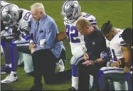  ?? AP/MATT YORK ?? Dallas Cowboys owner Jerry Jones and head Coach Jason Garrett join the team in kneeling on the field before the national anthem prior to Monday night’s game against the Arizona Cardinals in Glendale, Ariz.