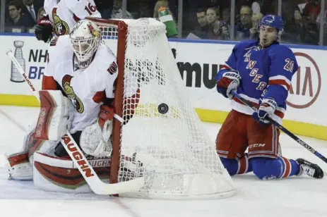  ?? MARY ALTAFFER/THE ASSOCIATED PRESS ?? Senators goalie Andrew Hammond stands his ground against the Rangers’ Chris Kreider during play Thursday night at Madison Square Garden.