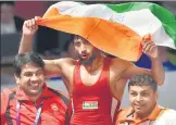  ?? PTI ?? ▪ Bajrang Punia carries the tricolour after winning the men’s freestyle wrestling (65kg) against Japan’s Daichi Takatani at the Asian Games 2018 in Jakarta on Sunday.