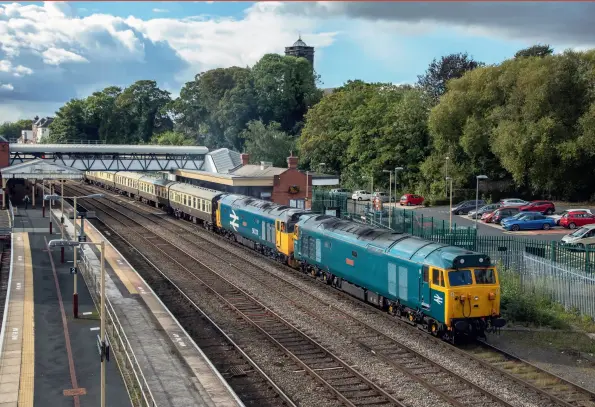  ??  ?? ABOVE: The GBRf 2021 charity railtour will feature a superb mix of traction,
including the ever-popular Class
50, this time in triple header form between Preston and Bescot. The 2018 ‘Out of the Ordinary’ tour featured 50007
Hercules (as 50006) and 50049 Defiance (as 50011), here taking the
platform road through Wellington, Shropshire, with the 1500 Crewe to Paddington leg
on the final day, September 23, 2018. (Richard Hargreaves)