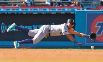  ?? MARK J. TERRILL/AP ?? Anthony Volpe dives but cannot make the play on a ground ball from Robert Hassell III during the second inning of the MLB All-star Futures game on July 16, 2022, in Los Angeles.