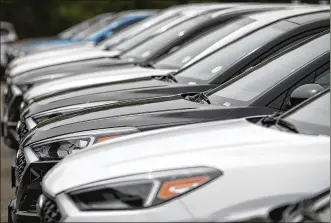  ?? DAVID ZALUBOWSKI / ASSOCIATED PRESS ?? Tucson sport utility vehicles sit at a Hyundai dealership in Littleton, Colo. With the cost to own a new vehicle rising, it’s more important than ever to consider what you’ll pay for a car loan and to shop for the best interest rate.