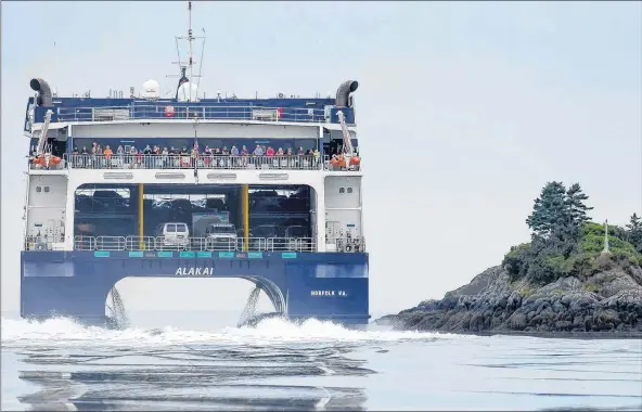  ?? ERVIN OLSEN PHOTO ?? The Cat ferry passing the Ships Stern Light while leaving Yarmouth harbour, sailing past Cape Forchu, during an August 2018 crossing.