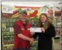  ?? SUBMITTED PHOTO ?? Tim Wright, assistant manager of the Hamilton Tractor Supply Store, presents Madison FFA reporter Emily Egan with a check for $1,419for the Grants for Growing award.