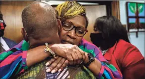  ?? Pool / TNS ?? Ahmaud Arbery’s mother, Wanda Cooper-Jones, is hugged by a supporter after the jury convicted Travis McMichael in the trial of McMichael, his father, Greg McMichael, and neighbor, William “Roddie” Bryan, on Wednesday.