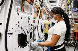  ?? ?? A Ford employee works at Ford’s Dearborn, Mich., truck plant. By 2025, Ford's Michigan operations will run with 100 percent renewably sourced electricit­y.