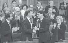  ?? ADRIAN WYLD THE CANADIAN PRESS ?? Finance Minister Bill Morneau shakes hands with Prime Minister Justin Trudeau after the unveiling of a fiscal update that included $14 billion in temporary write-offs for capital investment and a push to boost export markets.