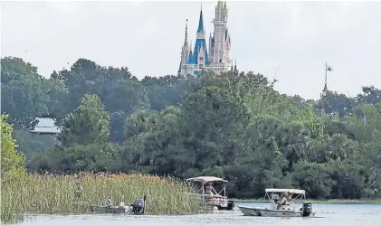  ?? AP ?? Rastrillaj­e. Una lancha anfibia buscaba ayer en los pantanos rastros del niño. De fondo, el Magic Kingdom.