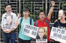  ?? — Reuters ?? Student leader Joshua Wong (2nd L) chants slogans demanding the release of Liu Xiaobo outside China’s Liaison Office in Hong Kong on Tuesday.