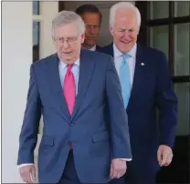  ?? PABLO MARTINEZ MONSIVAIS / AP ?? Senate Majority Leader Mitch Mcconnell of
Ky., followed by Senate Majority Whip John Cornyn of Texas. and Sen. John Thune, R-S.D., make their way Wednesday to speak to members of the media after a White House luncheon between GOP senators and...